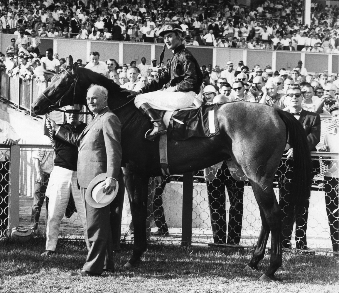 Buckpasser (Braulio Baeza up) in the winner's circle with owner Ogden Phipps for the 1966 Arlington Classic at Arlington Park (Museum Collection)