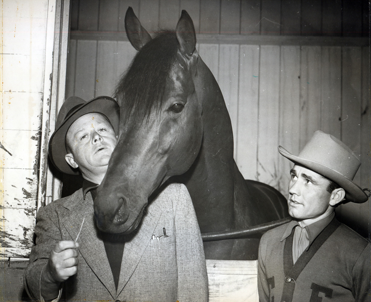 Jimmy Jones, Citation and jockey Steve Brooks in the barn area at Hollywood Park in 1951 (Hollywood Park Photo/Museum Collection)