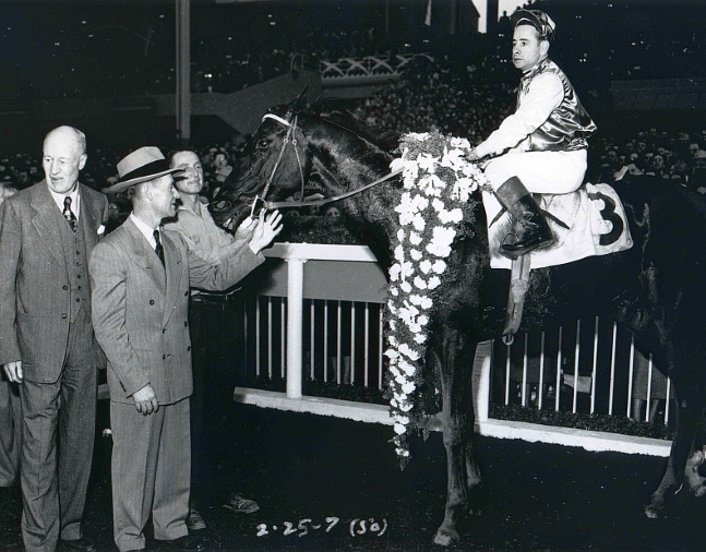 Noor (Johnny Longden up) in the winner's circle for the 1950 Santa Anita Handicap (Bill Mochon/Museum Collection)