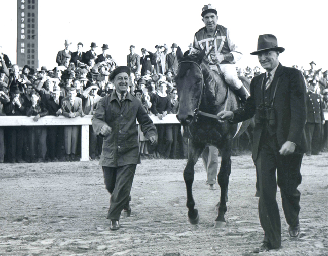 Seabiscuit (George Woolf up) and Tom Smith after defeating Triple Crown winner War Admiral in the 1938 Pimlico Special (Keeneland Library Morgan Collection/Museum Collection)