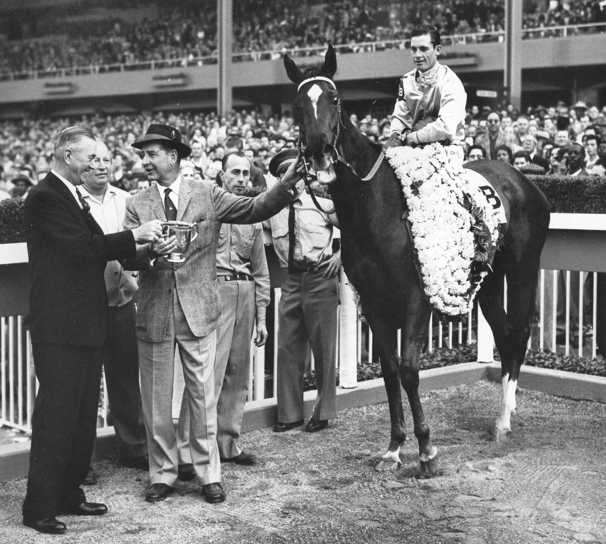 Silver Spoon in the winner's circle (Raymond York up) with owner C. V. Whitney after winning the 1959 Santa Anita Derby at Santa Anita Park (Wide World Photos/Museum Collection) 