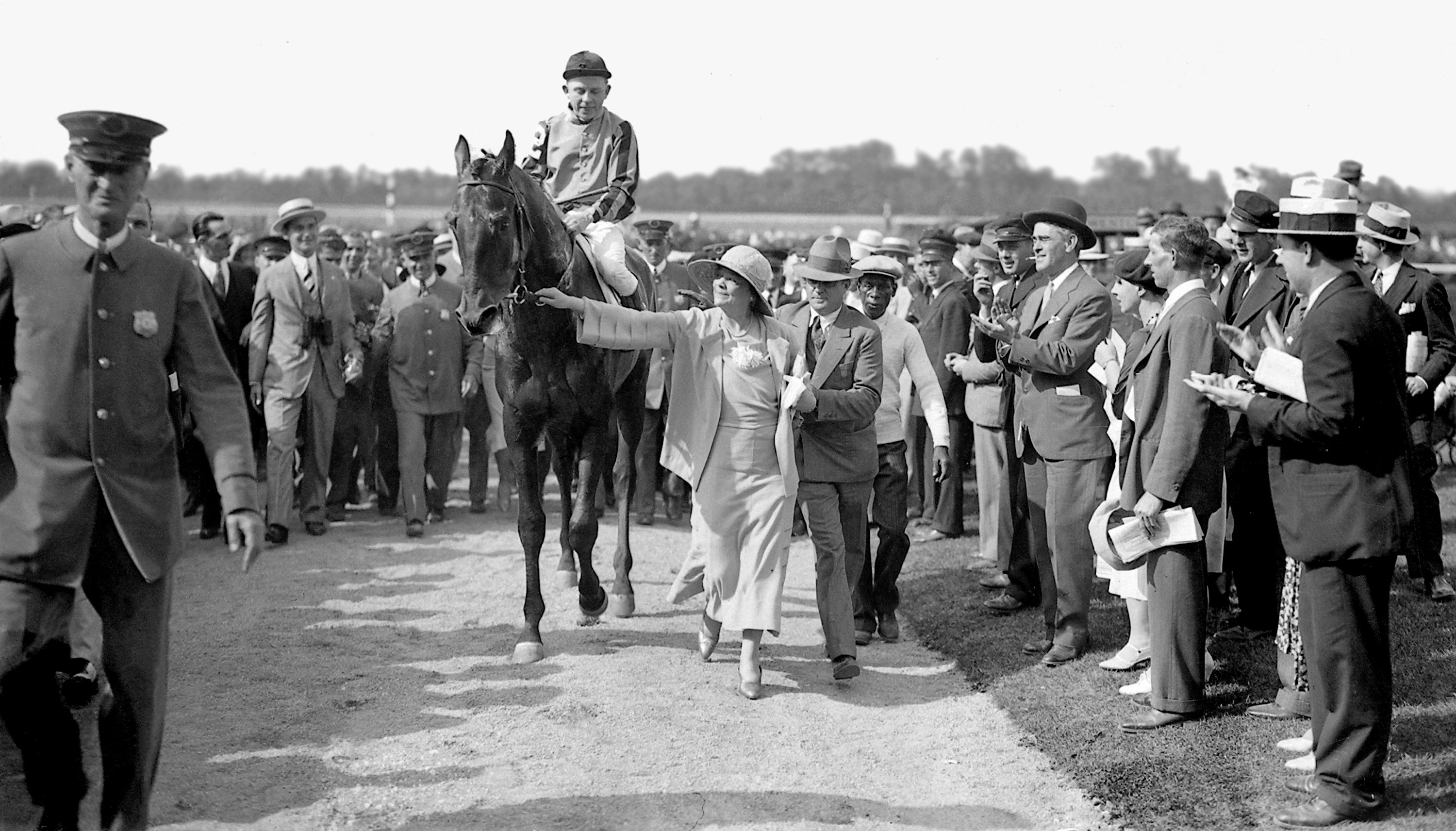 Helen Hay Whitney leading Twenty Grand (Charles Kurtsinger up) into the Belmont winner's circle (Keeneland Library Cook Collection)