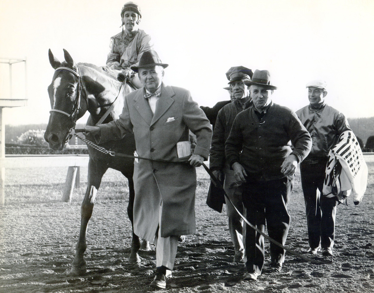 Sam Boulmetis and Mahan enter the winner's circle after winning the 1957 Washington D.C., International at Laurel (Museum Collection)
