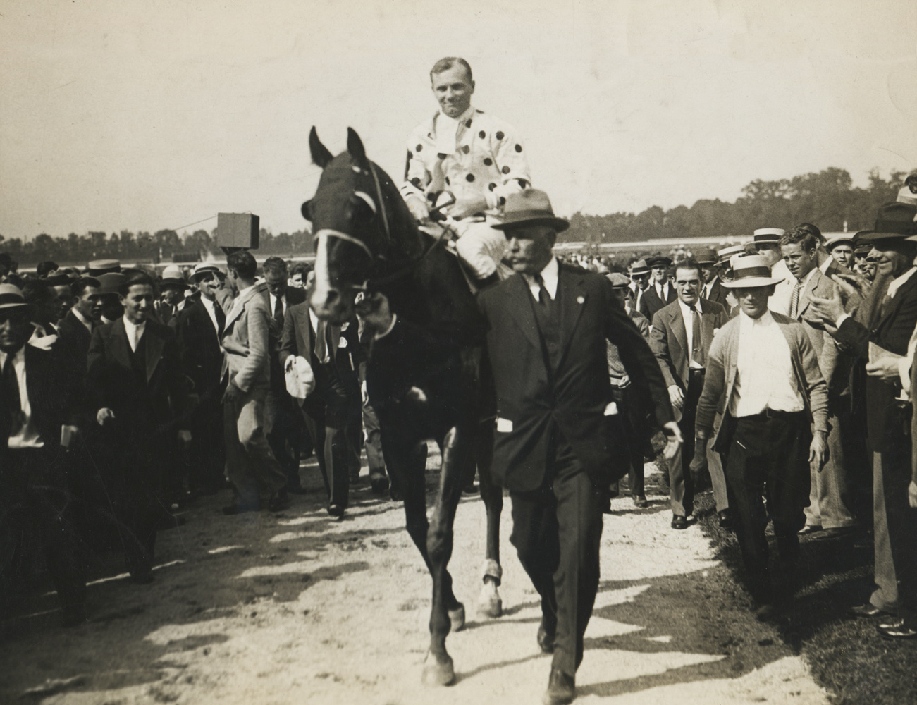 Owner William Woodward, Jr. leading in Gallant Fox and Earl Sande after winning the 1930 Lawrence Realization at Belmont Park (Pictorial Press Photos/Museum Collection)