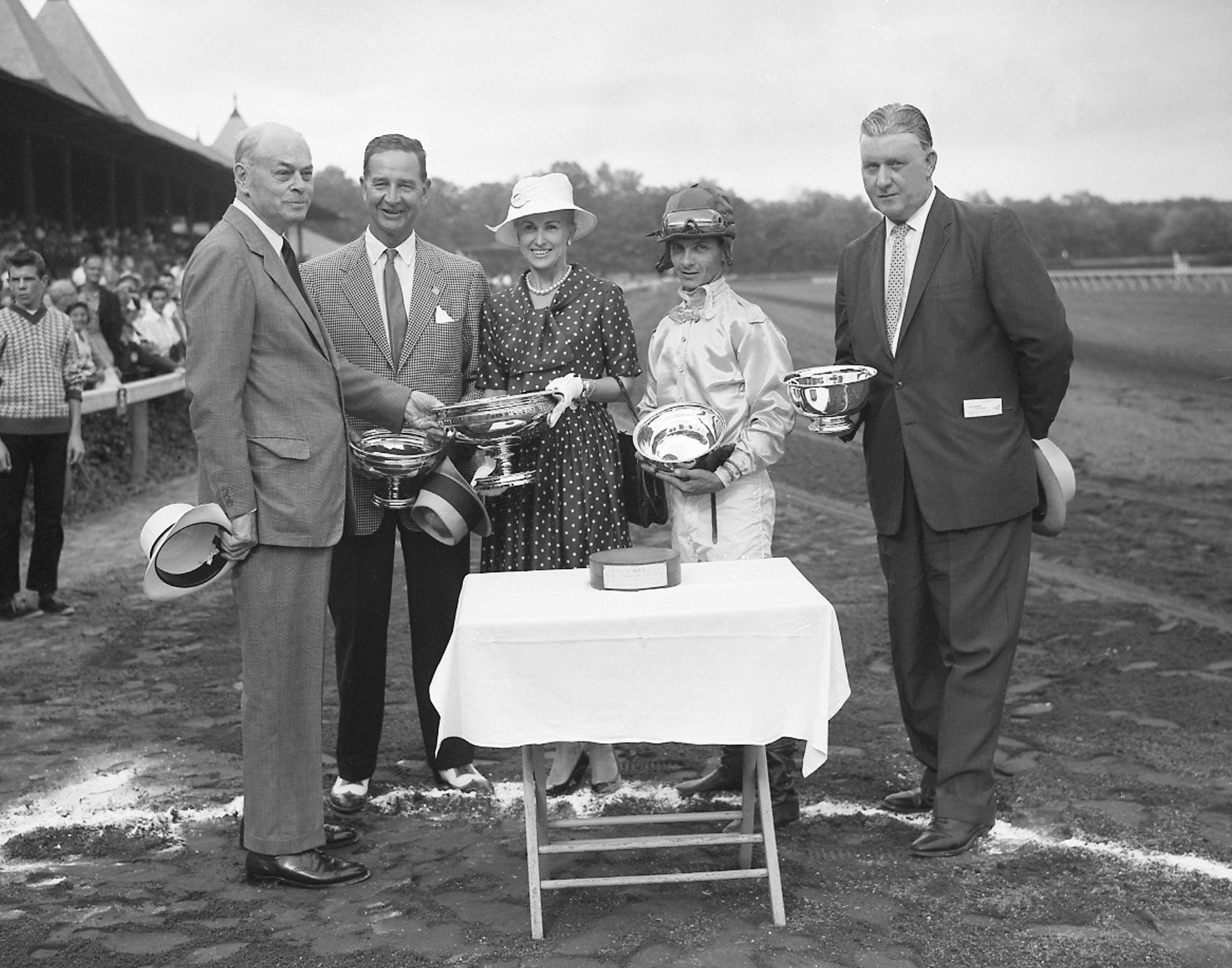 Walter M. Jeffords, Sr. presents the winning connections of Tompion - owners Mr. and Mrs. C. V. Whitney, jockey Bill Hartack, and trainer JJ Greely -  with the 1960 Travers Stakes trophy at Saratoga (Keeneland Library Morgan Collection)