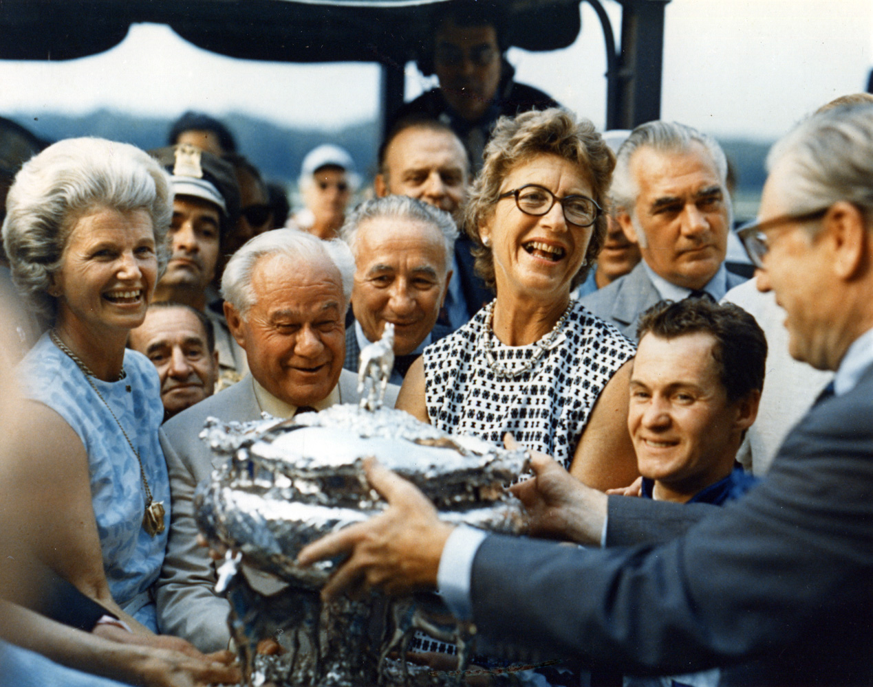 Penny Chenery, trainer Lucien Laurin, and jockey Ron Turcotte receive the August Belmont Memorial Trophy from New York Governor Nelson D. Rockefeller after Secretariat wins the 1973 Belmont Stakes and Triple Crown (NYRA/Museum Collection)