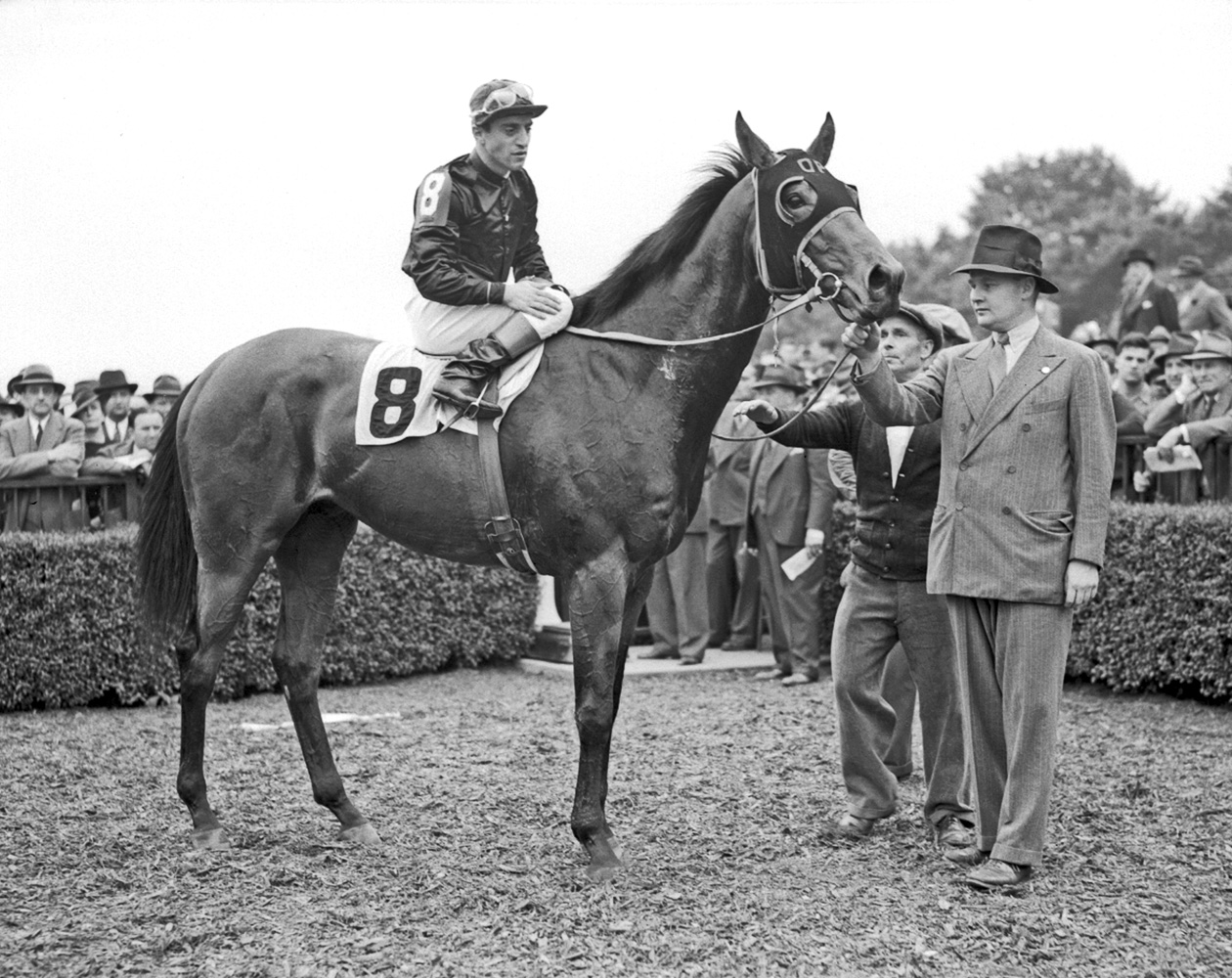 Ogden Phipps holding King Cole in the winner's circle (Keeneland Library Cook Collection)