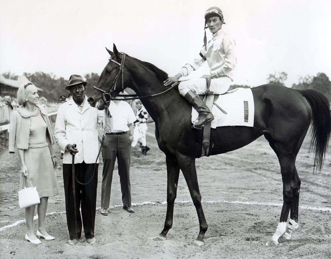 Marylou Whitney in the winner's circle at Saratoga with an unidentified horse (Braulio Baeza up) (NYRA/Museum Collection)