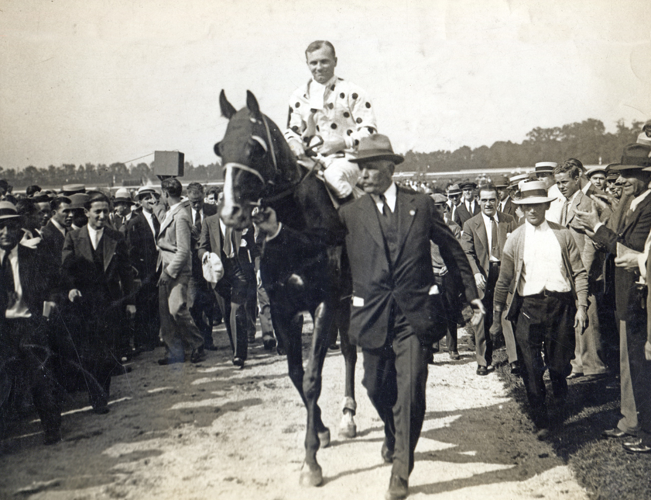 William Woodward, Sr. leads in Gallant Fox (Earl Sande up) after winning the 1930 Lawrence Realization at Belmont Park (Pictorial Press Photos/Museum Collection)