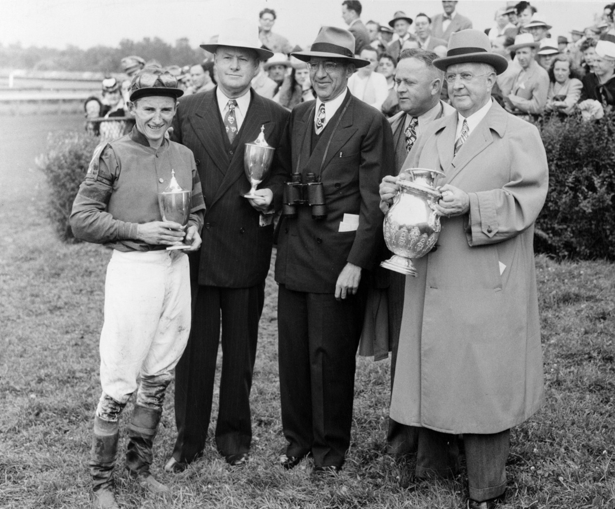 Jockey Doug Dodson, Ben Jones, B.F. Lindheimer, Jimmy Jones and Warren Wright accept the trophies for the 1945 Arlington Classic, won by Pot O'Luck (Keeneland Library Thoroughbred Times Collection)