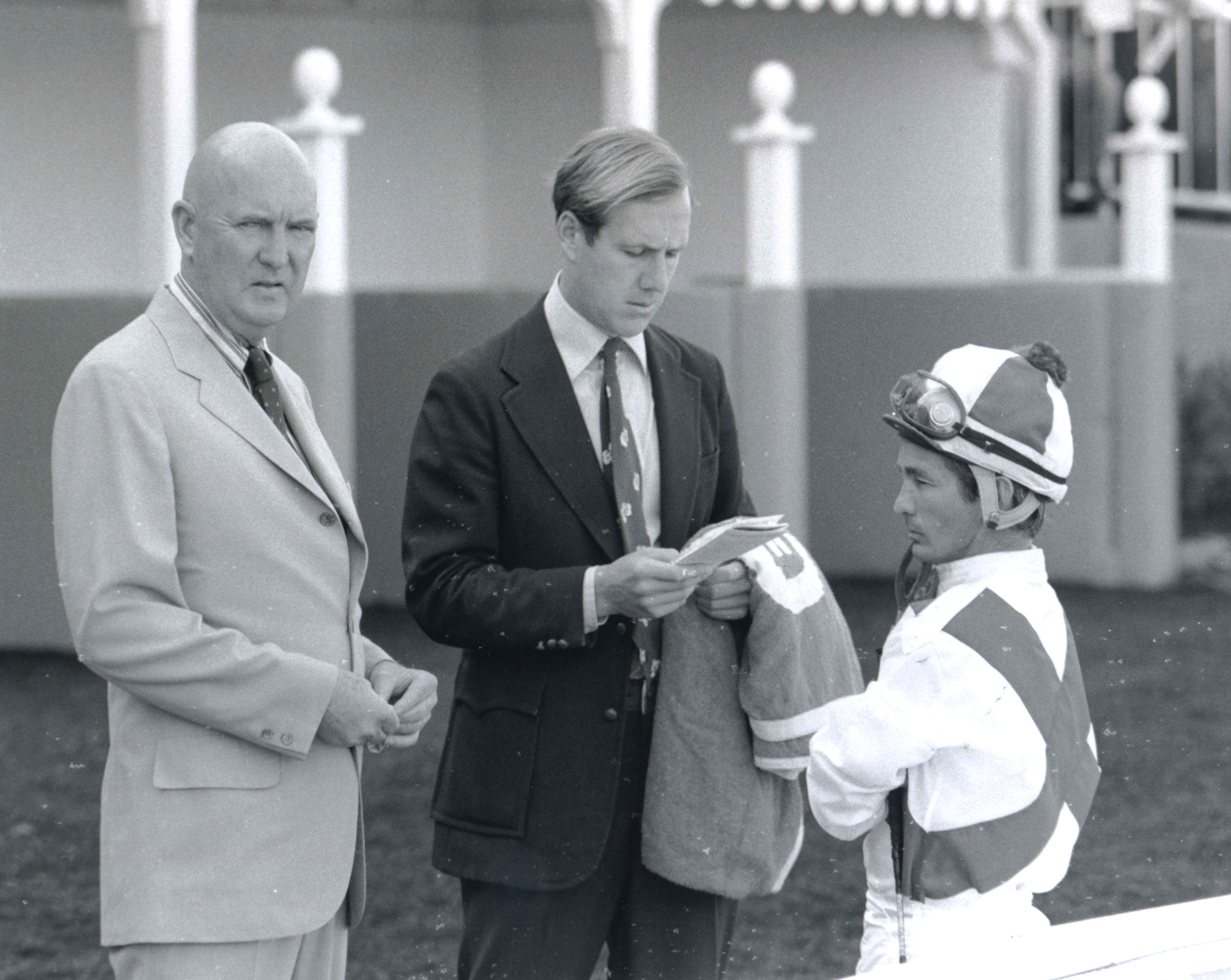 Charles Whittingham, Neil Drysdale, and Bill Shoemaker talk strategy in the saddling area at Hollywood Park in 1973 (Bill Mochon/Museum Collection)