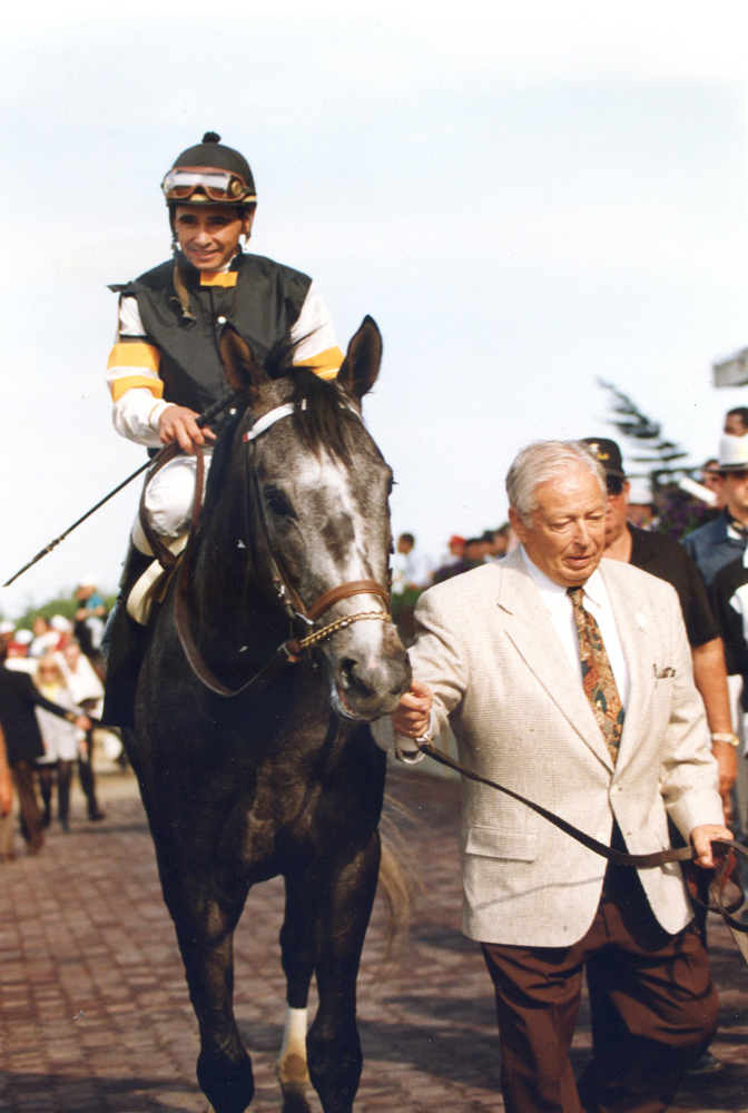 Holy Bull (Mike Smith up) being led in by trainer Jimmy Croll after winning the 1994 Metropolitan at Belmont Park (Barbara Ann Giove Coletta/Museum Collection)