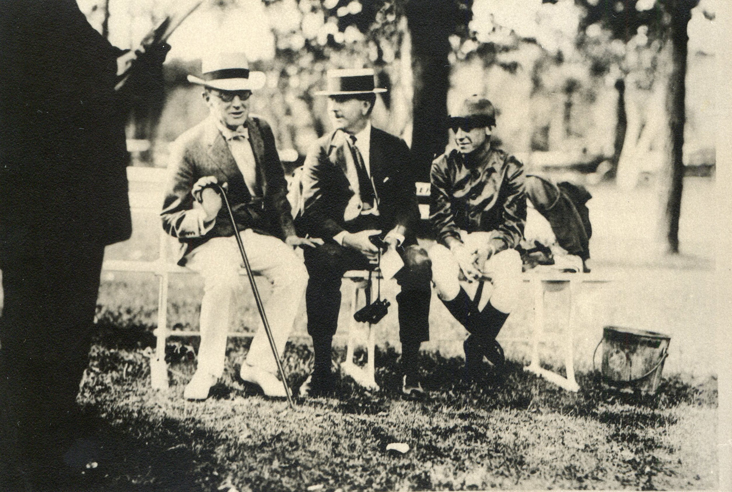 Trainer Tom Healey (center) and jockey Mack Garner share a bench with another unidentified man at Saratoga in 1920 (Museum Collection)
