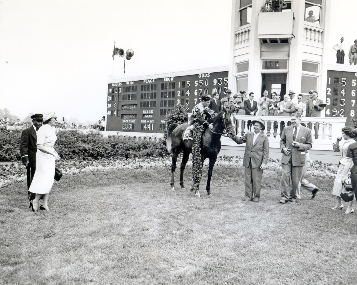 The winning connections of Determine, including trainer William Molter, celebrate in the winner's circle after winning the 1954 Kentucky Derby (Churchill Downs Inc./Kinetic Corp. /Museum Collection)