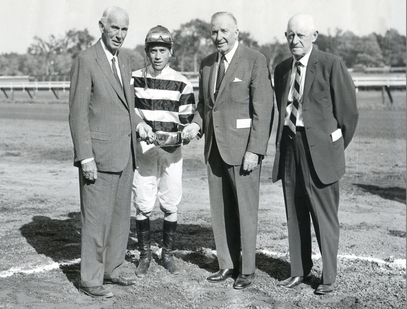 Owner George D. Widener, Jr., jockey John Rotz, John Hanes, and trainer Bert Mulholland at the trophy presentation for the 1966 Flash Stakes at Saratoga, won  by Bold Hour (Museum Collection)