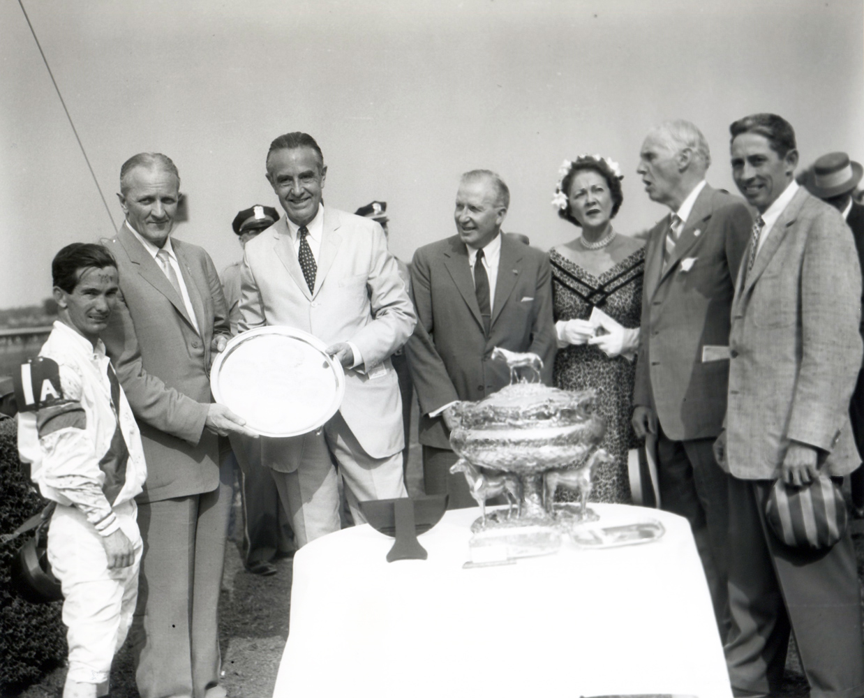 New York Governor Averill Harriman presents jockey Bill Shoemaker at far left, owner Ralph Lowe next to him, and trainer John Nerud at far right with the 1957 Belmont Stakes trophy (Keeneland Library Morgan Collection/Museum Collection)