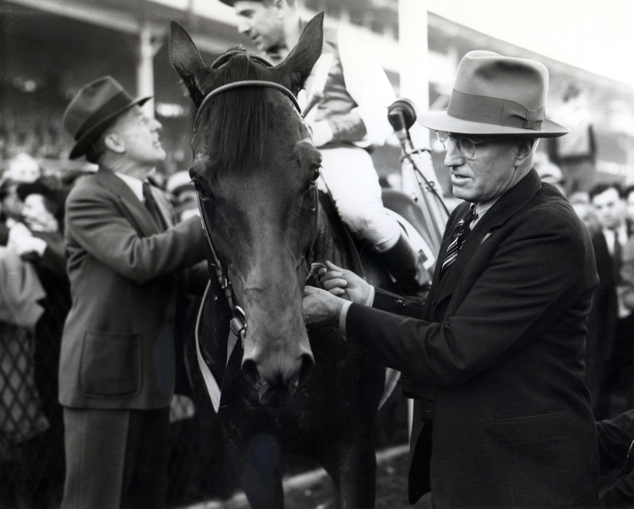 Tom Smith holds Seabiscuit's bridle at the 1938 Pimlico Special (George Woolf up) (Keeneland Library Cook Collection/Museum Collection)