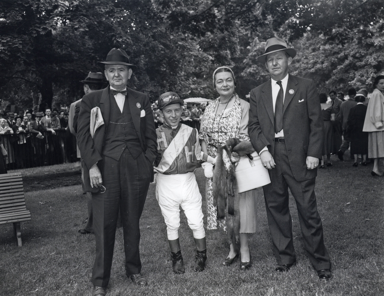 Mr. A. E. Reuben, jockey John Adams, Mrs. A. E. Reuben, and Harry Trotesk in the paddock at Belmont, May 1954 (Keeneland Library Morgan Collection/Museum Collection)