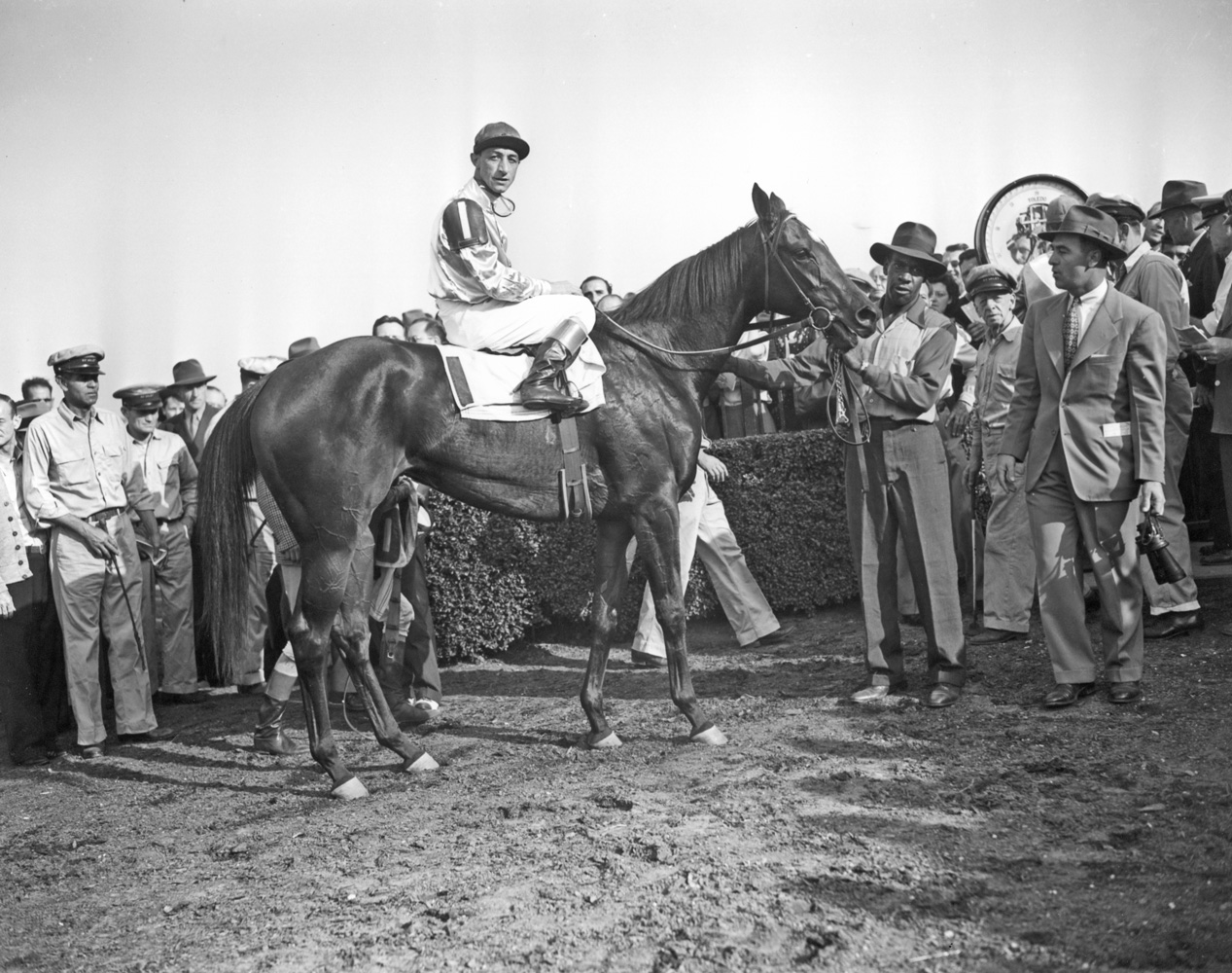 Trainer Sylvester Veitch in the winner's circle with First Flight (Eddie Arcaro up) for the 1946 Belmont Futurity (Keeneland Library Morgan Collection/Museum Collection)