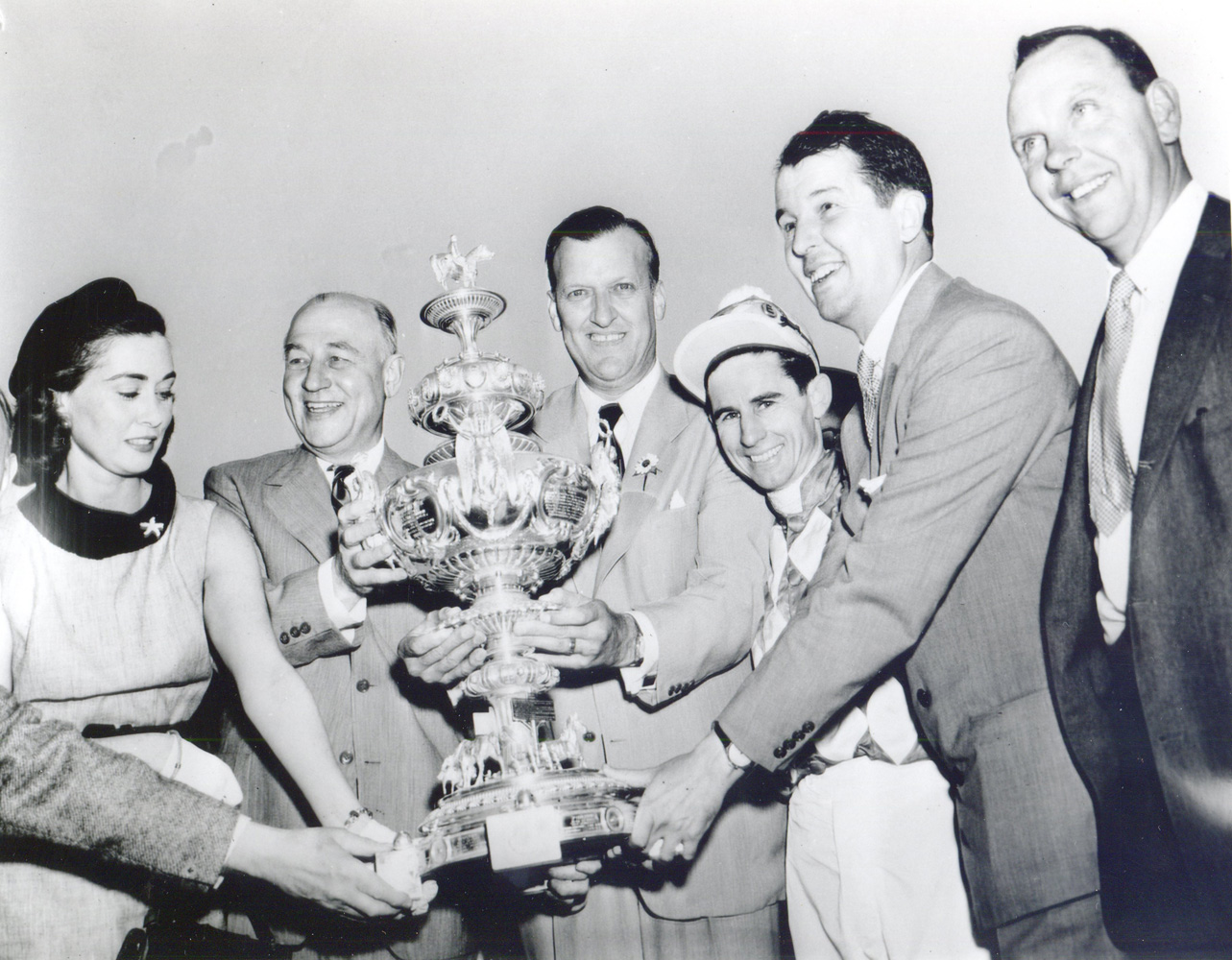 Mr. and Mrs. Alfred G. Vanderbilt, George M. Humphrey, Theodore R. McKeldin, jockey Eric Guerin, and trainer W. C. Winfrey celebrate Native Dancer's win at the 1953 Preakness trophy presentation (Keeneland Library Morgan Collection/Museum Collection)