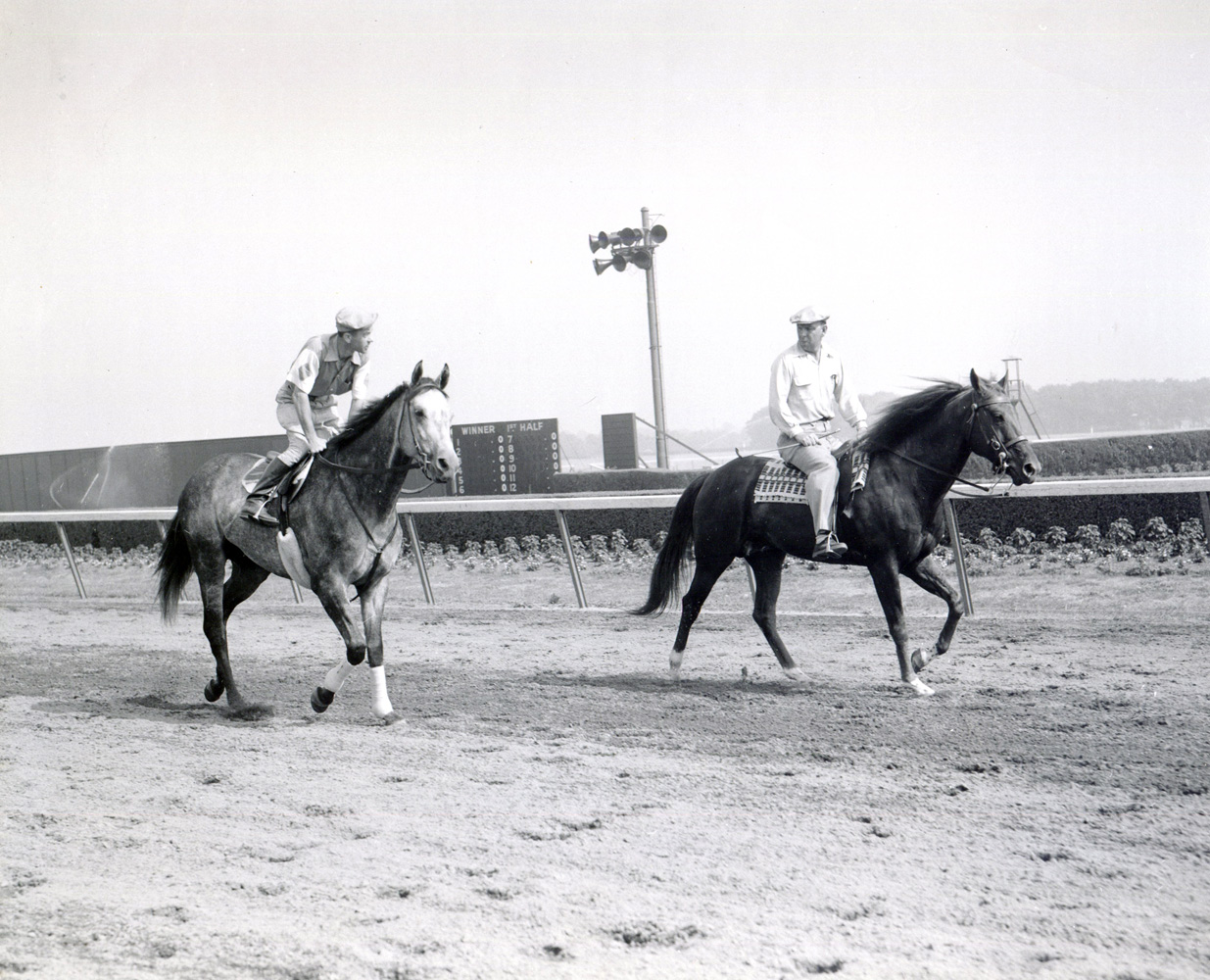 William C. Winfrey on a pony (on right) with Native Dancer and exercise rider B. Everson on the track (Museum Collection)