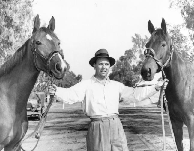 William C. Winfrey holding two unidentified horses in 1971 (Museum Collection)